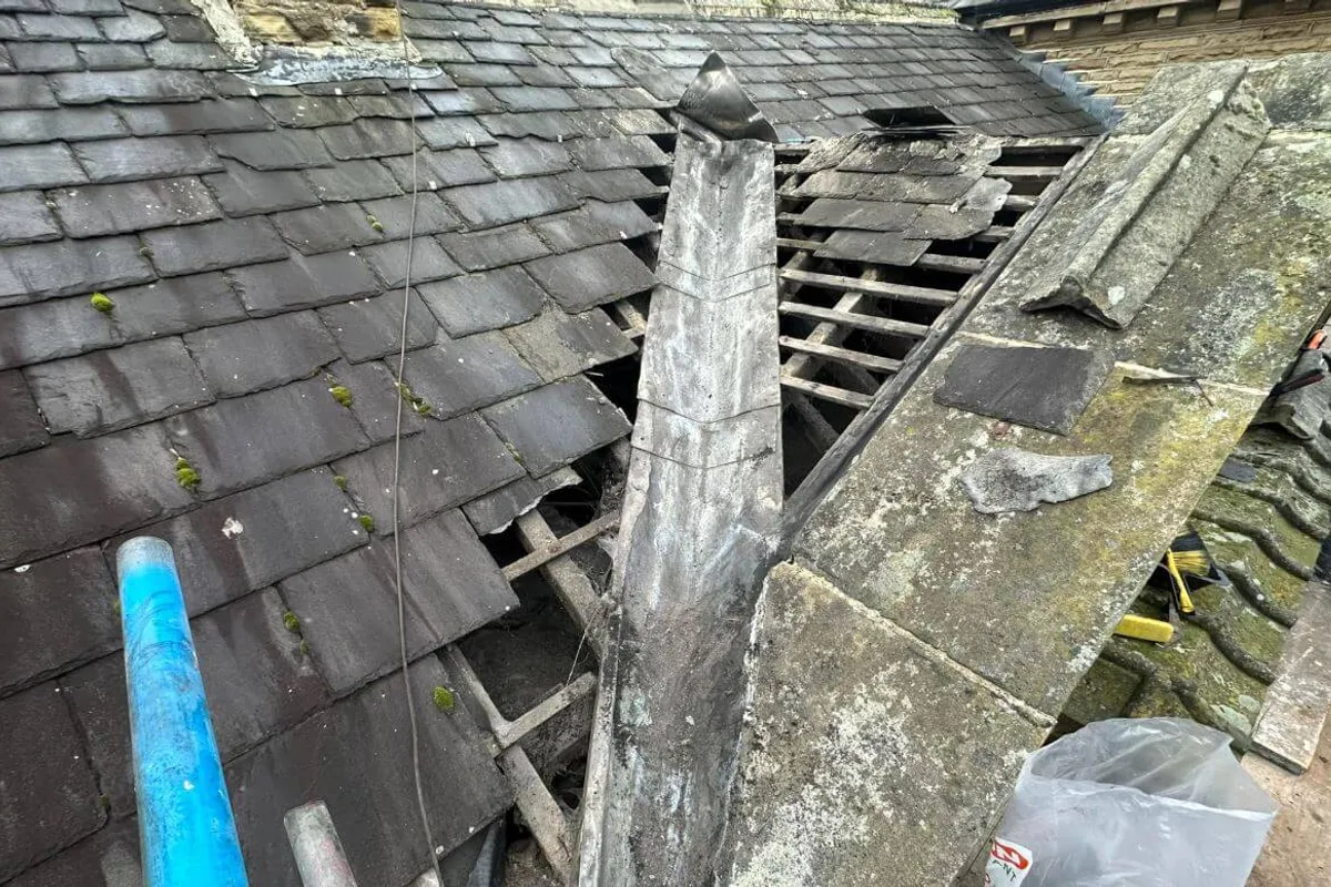A roofer carrying out a repair on a pitched roof